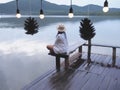 Woman sitting on the bench at sunrise beach background Royalty Free Stock Photo