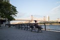 Woman Sitting on a Bench in Sutton Place Park South by the East River in New York City