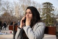 Woman sitting on a bench talking with her mobile in a park Royalty Free Stock Photo