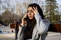 Woman sitting on a bench talking with her mobile in a park Royalty Free Stock Photo