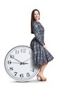 Woman sitting on big clock Royalty Free Stock Photo