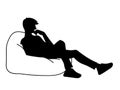 Woman sitting on big pillow. Stencil. Vector illustration of black silhouette isolated on white background. Thoughtful