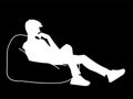 Woman sitting on big pillow. Stencil. Vector illustration of white silhouette isolated on black background. Thoughtful