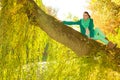 Woman sitting on big tree trunk Royalty Free Stock Photo