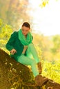 Woman sitting on big tree trunk Royalty Free Stock Photo