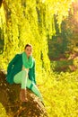 Woman sitting on big tree trunk Royalty Free Stock Photo