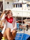 Woman sitting on bitt in marina Royalty Free Stock Photo