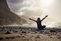 Woman sitting on black sand volcanic Beniho Benijo Beach - North part of Tenerife. Canary Islands. Spain Royalty Free Stock Photo