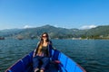 Pokhara - A woman sitting in a blue boat and enjoying the tour Royalty Free Stock Photo