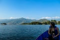 Pokhara - A woman sitting in a blue boat and enjoying the tour Royalty Free Stock Photo