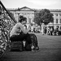 Woman sitting in the bridge of arts in paris Royalty Free Stock Photo