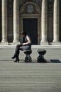 Woman sitting in the bridge of arts in paris Royalty Free Stock Photo