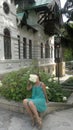 Woman sitting with bunch of flowers hiding face