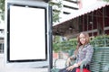 Woman sitting at a bus stop bench Royalty Free Stock Photo