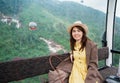 Woman sitting in Cable car with Ba Na Hills Mountain in the fog. Landmark and popular. Da Nang, Vietnam and Southeast Asia travel Royalty Free Stock Photo