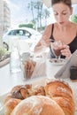 Woman sitting at the cafe with sicilian granita and croissants