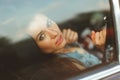 Woman sitting in car behind window, tinted photo Royalty Free Stock Photo