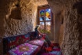 Woman sitting in cave house and looking to windows with beautiful scenic in Goreme, Cappadocia, Turkey.