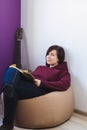 Woman sitting on a chair and compose a new song Royalty Free Stock Photo