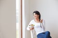 Woman Sitting In Chair Eating Bowl Of Fresh Fruit Royalty Free Stock Photo