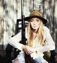 Woman sitting in chair with a gun Royalty Free Stock Photo