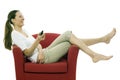 Woman sitting on a chair with remote control Royalty Free Stock Photo