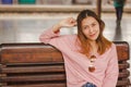 Woman sitting in a chair in a train station Royalty Free Stock Photo