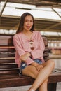 Woman sitting in a chair in a train station Royalty Free Stock Photo