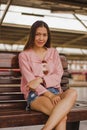 Woman sitting in a chair in a train station Royalty Free Stock Photo