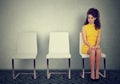 Woman sitting on a chair waiting for job interview