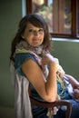 Woman sitting in chair by window