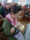 Woman sitting in church pew drinking coconut milk