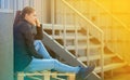 Woman sitting in city. Street photo.