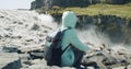 Woman sitting at cliff edge Defocused running river falling into Detifoss waterfall in background Iceland Royalty Free Stock Photo