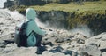 Woman sitting at cliff edge enjoying Detifoss waterfall in Iceland Royalty Free Stock Photo