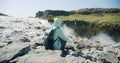 Woman sitting at cliff edge enjoying Detifoss waterfall in Iceland Royalty Free Stock Photo