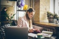 Woman sitting coffee shop wooden table, drinking coffee and using smartphone. Woman Using Phone In Cafe. Student learning online. Royalty Free Stock Photo