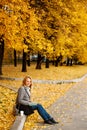 Woman sitting on a curb and writing something in her noteboo Royalty Free Stock Photo