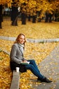 Woman sitting on a curb writing something in her notebook Royalty Free Stock Photo