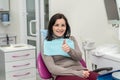 Woman sitting in dentist chair showing thumb up Royalty Free Stock Photo