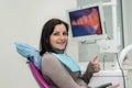 Woman sitting in dentist chair showing thumb up Royalty Free Stock Photo