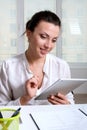 Woman sitting at a desk in an office is studying the information