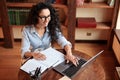 Woman sitting at desk, using computer and typing on keyboard Royalty Free Stock Photo