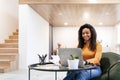 Woman sitting at desk, using computer and writing in notebook Royalty Free Stock Photo