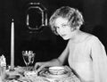 Woman sitting at the dinner table Royalty Free Stock Photo