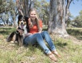 Woman Sitting with Dog in Park.