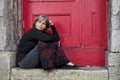 Woman sitting on door stoop