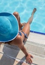 Woman sitting on a edge of swimming pool. Royalty Free Stock Photo