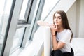 Woman sitting on the end of bed near big window Royalty Free Stock Photo