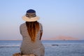 Woman sitting enjoying a tranquil sunset